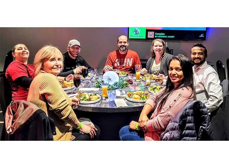 Company staff having dinner at a large round table